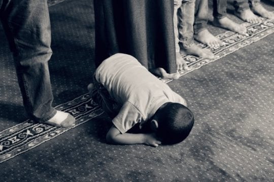 How to drag your feet to prayer when you feel not praying - in the image, a child in sujood